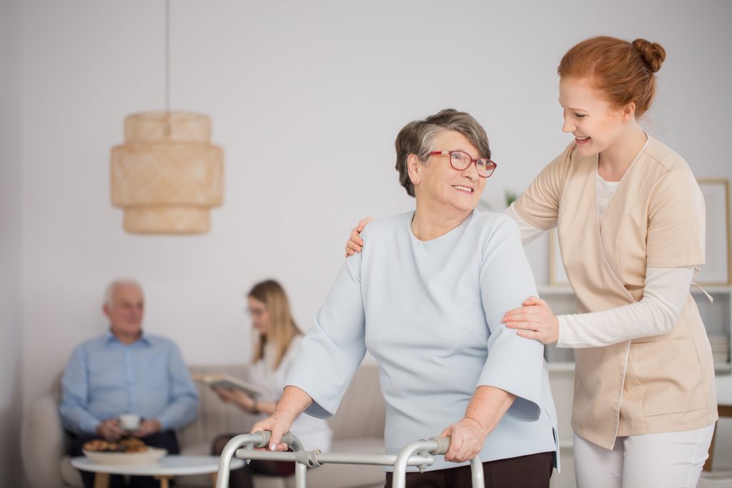 Assisted living resident receives help from assisted living caregiver